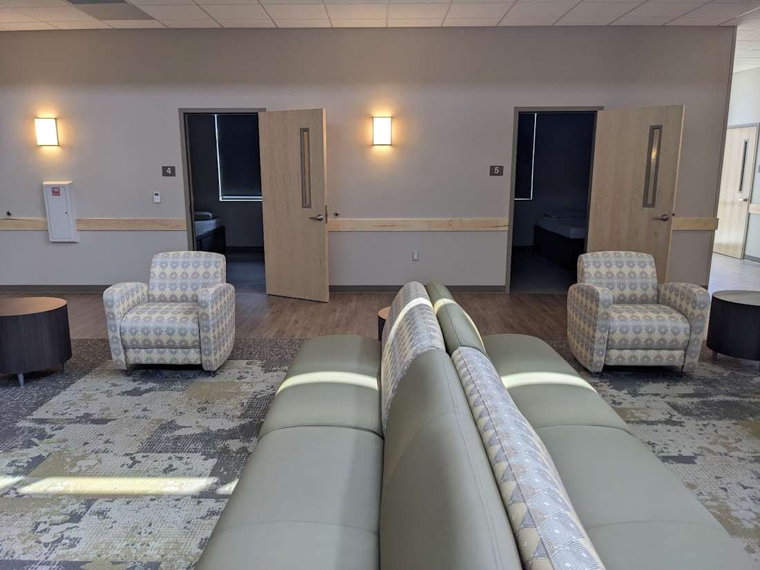 Lounge area with chairs, tables, and partially open doors labeled 4 and 5